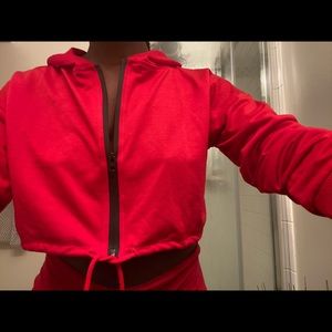 Red cropped hoodie w/ black zipper.